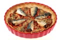 Homemade sardine pie in a dish close-up on white background