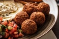 Close-up of Traditional falafel balls with salad and hummus on a