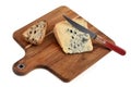 Piece of Bleu d`Auvergne on a cutting board with bread and knife on white background Royalty Free Stock Photo