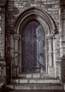 Close-up of traditional gothic medieval wooden entrance doorway with ancient brick arc, mystical portal Royalty Free Stock Photo