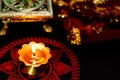 Close-up of traditional puja set-up for diwali worship with rangoli art in background chunari chonki and brass lamp. diwali Royalty Free Stock Photo