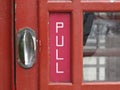 Close up of a traditional red british telephone box door Royalty Free Stock Photo