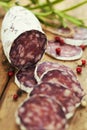Traditional sliced meat sausage salami on wooden board