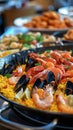 A close-up of a traditional Spanish paella dish filled with shrimp, mussels, and saffron rice. Royalty Free Stock Photo