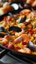 A close-up of a traditional Spanish paella dish filled with shrimp, mussels, and saffron rice. Royalty Free Stock Photo