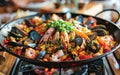 A close-up of a traditional Spanish paella dish filled with shrimp, mussels, and saffron rice. Royalty Free Stock Photo