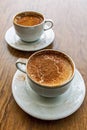 Traditional turkish hot drink sahlep or salep in white cup on brown background.