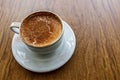 Traditional turkish hot drink sahlep or salep in white cup on brown background.