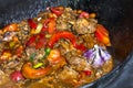 Close up of traditional Uzbek shurpa dish made from lamb and various vegetables at the open fire in cast iron cauldron Royalty Free Stock Photo