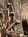 Close-up of a traditional waterwheel made of bamboo that is spinning with water flowing.