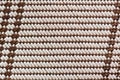 Close-up of traditional woven texture in brown and beige tones with geometric pattern. Natural background emphasizing handmade Royalty Free Stock Photo