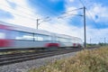 Close up of a train with overhead electrification speeding through English countryside with motion blur Royalty Free Stock Photo