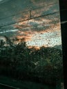 A close-up of a train window drenched in rain, blurring the outside view into an impressive scene. Royalty Free Stock Photo