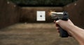 Handgun in focus: precise target shooting at a range with a steady grip and controlled breath Royalty Free Stock Photo