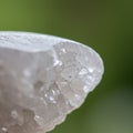 Close-up of a translucent quartz crystal with rough, faceted edges. The surface is Royalty Free Stock Photo