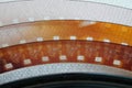 Clear acetate ribbon of 8 millimeter film against white background