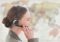 Close up of travel agent with headset against blurry map Royalty Free Stock Photo