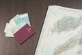 Close-up of travel biometric passport with a bundle of Malaysian ringgits amd opened map of Malaysia.Planning a tour concept Royalty Free Stock Photo