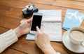 Close up of traveler hands with smartphone and map Royalty Free Stock Photo