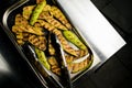 Close-up of tray with fried slices of zucchini on steel table. Royalty Free Stock Photo