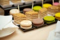Close up of tray with lot delicious diversity pastry cakes tartlets and macaroon in a row. Fresh, multicoloured, colourful, green,