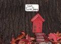 Whimsical red Fairy door in a tree trunk Royalty Free Stock Photo