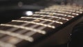 Close up of trembling guitar strings against fret. Chords being strummed and vibrating during playing. Beautiful