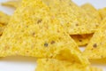 Close up, Triangular chips, mexican nachos, on white background. Perfect Tasty spicy snack for a beer Royalty Free Stock Photo