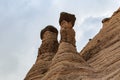 Close up of triangular rock formations against grey dark sky in Kasha-Katuwe Tent Rocks National Monument in New Mexico Royalty Free Stock Photo