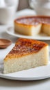 A Slice of Creamy Rice Pudding Cake with a Toasted Caramelized Top Presented on a White Plate Royalty Free Stock Photo