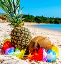 Close up of tropical fuits on the sand by the sea on a clear day