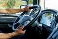 Close up of truck driver behind the steering wheel in a cabin Royalty Free Stock Photo