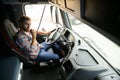 Close up of truck driver behind steering wheel. Copy space. Royalty Free Stock Photo