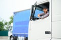 Close up of truck driver behind steering wheel. Copy space. Royalty Free Stock Photo