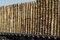 Close up of Truck loaded high with stacks of wooden pallets