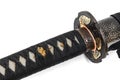 Close-up Tsuka : handle of Japanese sword wrapped by black silk cord with gold fitting isolated in white background. Royalty Free Stock Photo