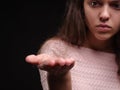 Close-up tuft of hair on a hand. Sad woman holding tangled hair on the black background. Hair loss concept. Copy space. Royalty Free Stock Photo