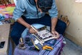 Close-up Tunisian street calligrapher preparing a gift for a tourist in Hammamet. Tunisia. Arabic calligraphy.