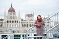 Close-up turist girl stands on steps against Hungarian Parliament, Budapest Royalty Free Stock Photo