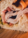 close up of turkey sandwich on bamboo cutting board Royalty Free Stock Photo