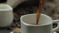 Close-up of turkish coffee poured from copper jezva into the white cup