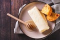 Close up of turkish creamy dairy kaymak, honey and bread on a breakfast plate top view Royalty Free Stock Photo