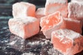 Close-up of Turkish Delight made from roses with sugar on blue marble, horizontal, Royalty Free Stock Photo