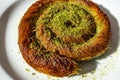 Close up turkish dessert kadayif. shredded wheat dessert with pistachio filling