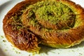 Close up turkish dessert kadayif. shredded wheat dessert with pistachio filling