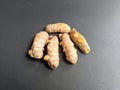 Close-up Turmeric Curcuma longa Linn rhizome root cutting isolated on dark background