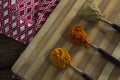 Turmeric powder, red chili powder, coriander powder on chopping board