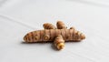 A close up of a turmeric root Curcuma longa on a white surface Royalty Free Stock Photo