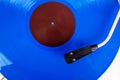 Close up of turntable needle on a blue vinyl