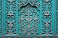 a close-up of a turquoise door with intricate carvings Royalty Free Stock Photo